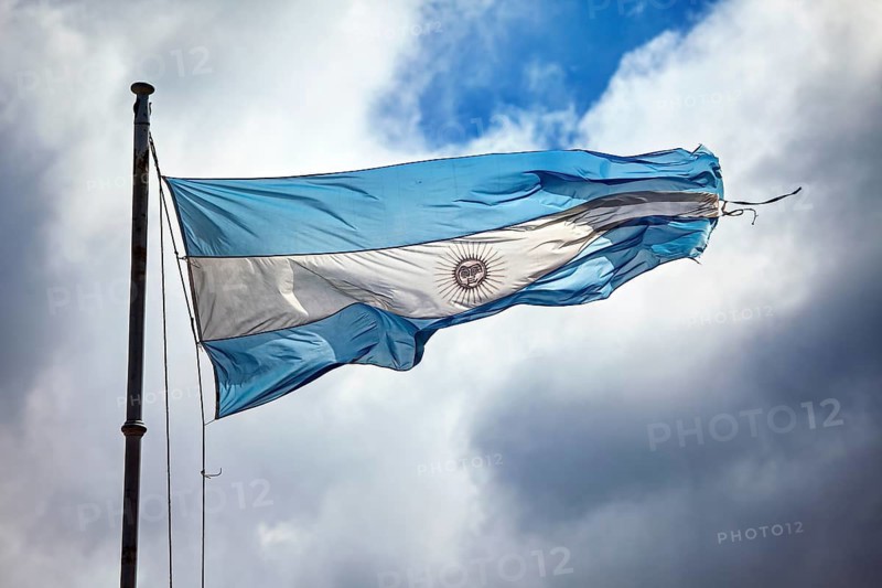 Argentine flag waving in the wind in front of a cloudy sky, The flag of Argentina waving in the wind