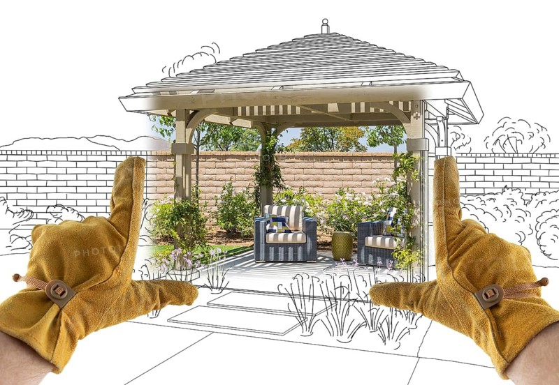 Male Contractor Hands Framing Completed Section of Custom Pergola Patio Cover Design Drawing