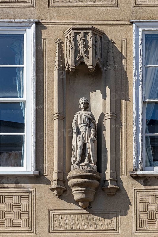 St Edmund statue on the wall of a house, Bury St Edmunds, West Suffolk, England, Great Britain