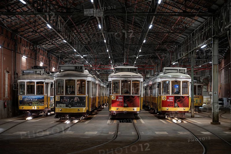 LISBON, PORTUGAL - MAY 19, 2025: Historic trams stand in the tram depot at night