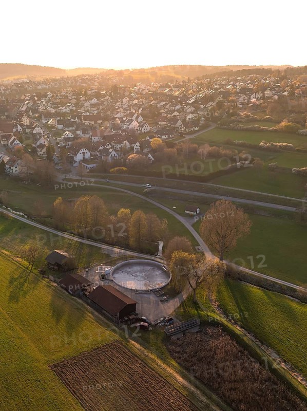 A village surrounded by wide fields and trees at sunset, quiet rural scenery, Gechingen, district of Calw, Black Forest, Germany
