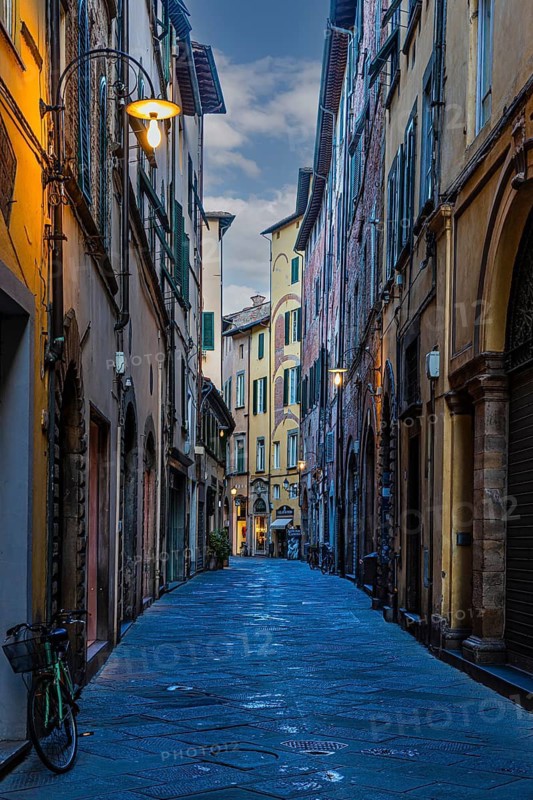 Narrow alley, historic city centre, at dawn, Lucca, Tuscany, Italy
