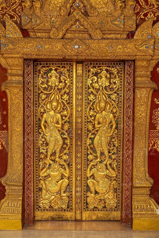 Door with golden reliefs of the Buddhist temple Wat Xieng Thong Luang Prabang, Laos