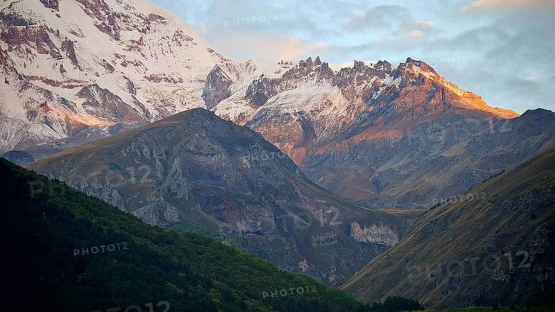 Snow-capped mountains at sunset, peaceful natural landscape, Stepantsminda, Caucasus, Georgia
