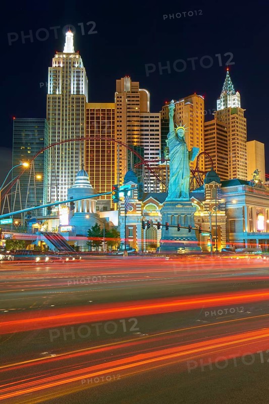Nighttime urban scene in Las Vegas with brightly lit New York-New York Hotel and Casino, the Strip, street, Las Vegas, Nevada, USA