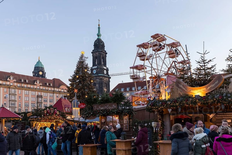 Christmas market Striezelmarkt on the Altmarkt with Kreuzkirche tower and Ferris wheel, Dresden, Saxony, Germany