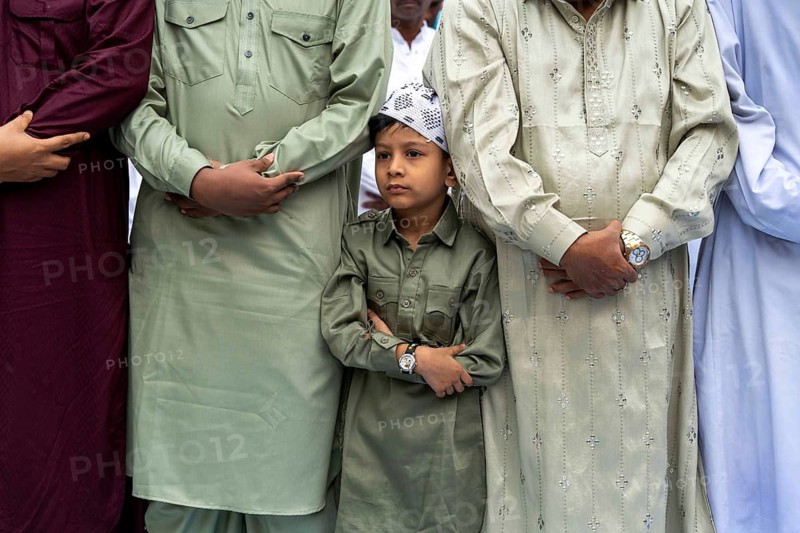 A Muslim child with elders attend to Eid al-Fitr prayer at Eidgah, on March 21, 2026 in Guwahati, India. Muslims make up a sizeable minority of India's population and celebrate Eid along with muslims across the world at the end of Ramadan