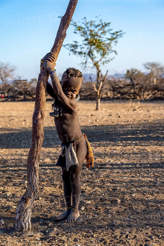 Himba child, in the morning light, traditional Himba village, Kaokoveld, Kunene, Namibia