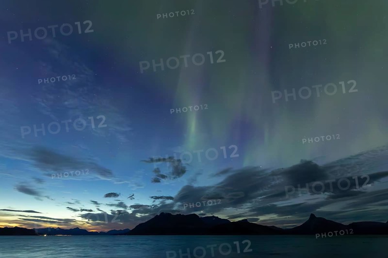 Northern lights at dawn over Sørfolda Fjord near Kjerringøy between Bodø and Sørfold in Norway