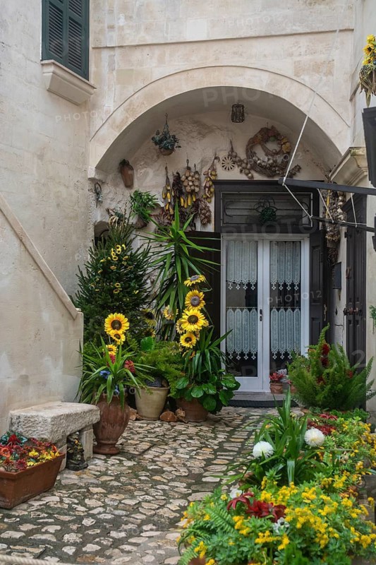 Entrance door with flowers in Matera, Basilicata, Southern Italy, Italy