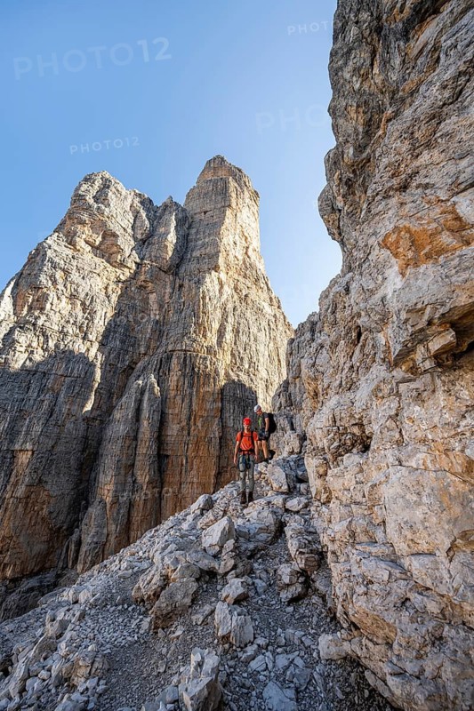 Two mountaineers on the Via Ferrata Bocciere Centrale via ferrata, spectacular mountain landscape with steep rock faces, Brenta Mountains, Parco Naturale Brenta-Adamello, Trentino, Italy
