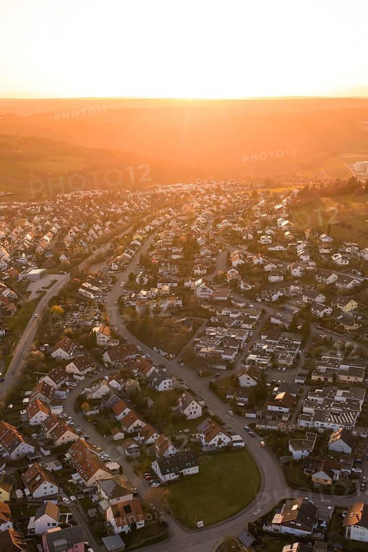 Aerial view of a settlement at sunset with rolling hills, Calw, Stammheim, Calw district, Germany