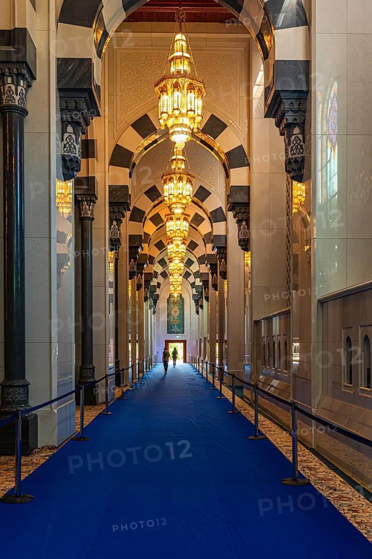 Side corridor with illuminated chandeliers in the Sultan Qaboos Mosque, Muscat, Arabian Peninsula, Sultanate of Oman