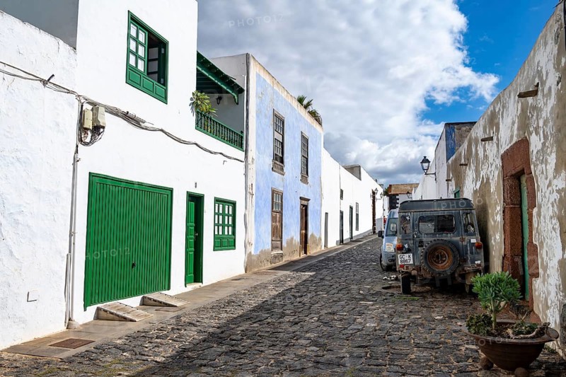 Typical white houses with colored doors and windows in an alley, Teguise, Lanzarote, Canary Islands, Spain