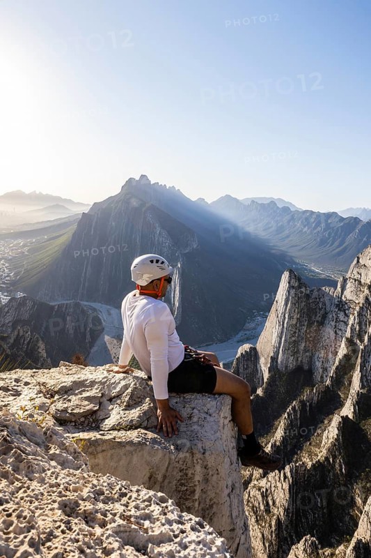A man takes a rest on the rocky cliffs of Eagleâ€™s Nest in Monterrey, Mexico, after practicing mountaineering and rappelling, enjoying the stunning mountainous view