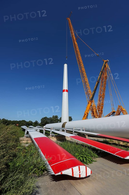 Dorsten, North Rhine-Westphalia, Germany, construction of a wind turbine, the first wind turbine of the Grosse Heide wind farm. The rotor blades are ready for assembly. A large mobile crane places the tower elements, the rings, on top of each other. This wind turbine will have a rated output of 5, 500 kW