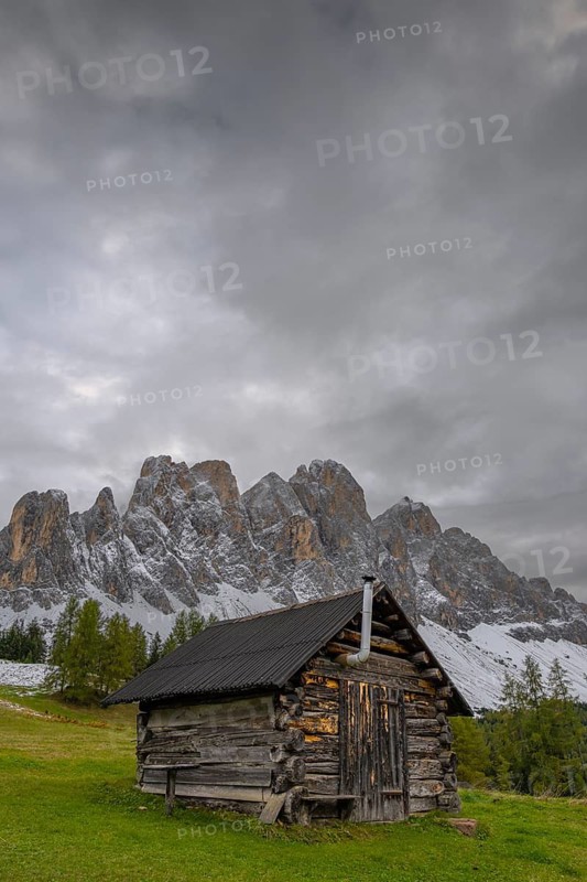 View of a part of the Geisler group from the Gampenwiese, in the foreground an alpine hut, Dolomites, snow, Puez-Geisler nature park Park, St. Magdalena, Funes, Villnößtal, South Tyrol, Italy