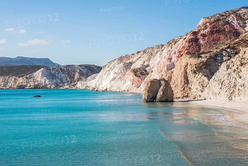 The stunning coastline of Milos Island, with crystal-clear turquoise waters, dramatic rocky cliffs, and serene sandy beaches. Experience the natural beauty and tranquility of the Greek islands