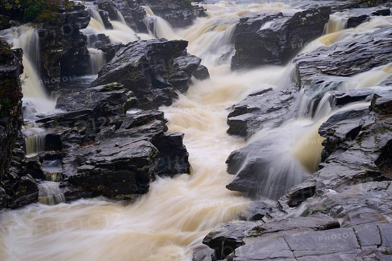 Close-up of wild water flowing through rocks of a river in dramatic flow, River Orchy, Eas Urchaidh, Bridge of Orchy, Scotland, United Kingdom, Great Britain