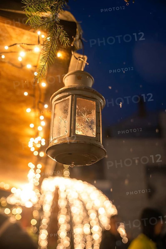 Close-up of an illuminated lantern at night with twinkling fairy lights, Calw Christmas market, Black Forest, Germany