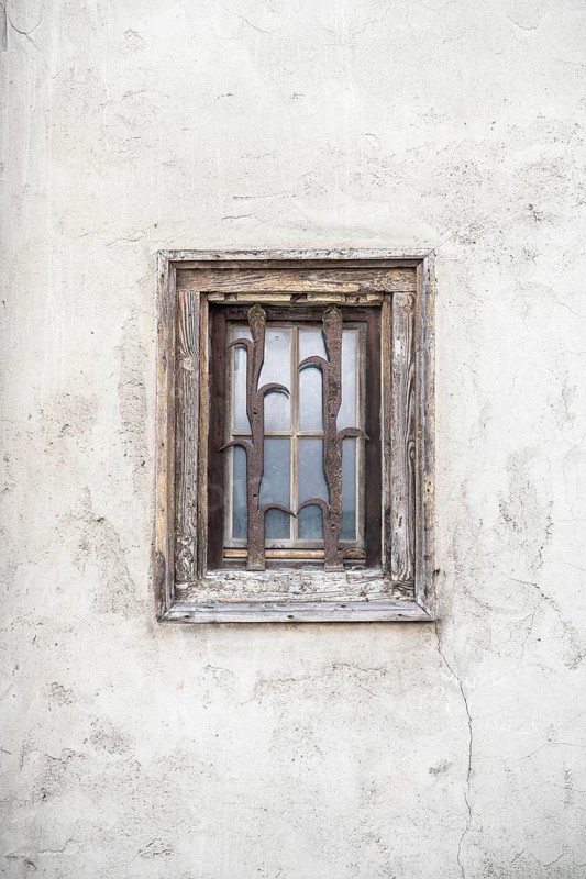 Detailed view of a historic town house in the historic old town of Rottweil with a window with weathered wooden frame and forged, rusted window grille, Rottweil district, Baden-Württemberg, Germany