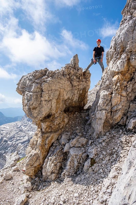 Mountaineer standing on a rock, Via Ferrate Benini via Ferrate, Brenta Mountains, Brenta-Adamello Natural Park, Trentino, Italy