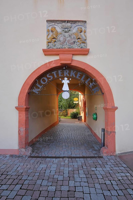 Inner courtyard and entrance to the Klosterkeller restaurant with coat of arms, passageway, archwayCastle, Philippsthal, Werra, Hesse, Germany
