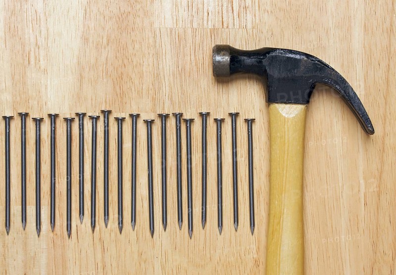 Hammer and Nails Abstract on Wood Background