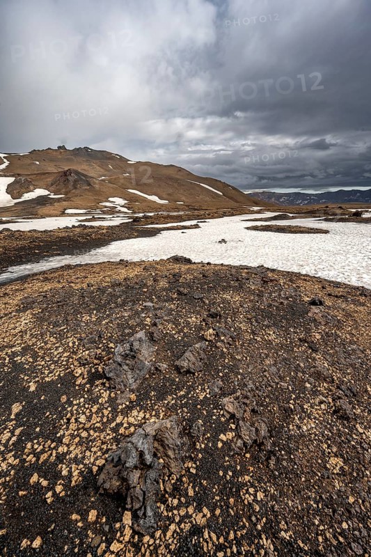 Snow-covered volcanic landscape with tuff and petrified lava, crater of Askja volcano, Icelandic highlands, Iceland
