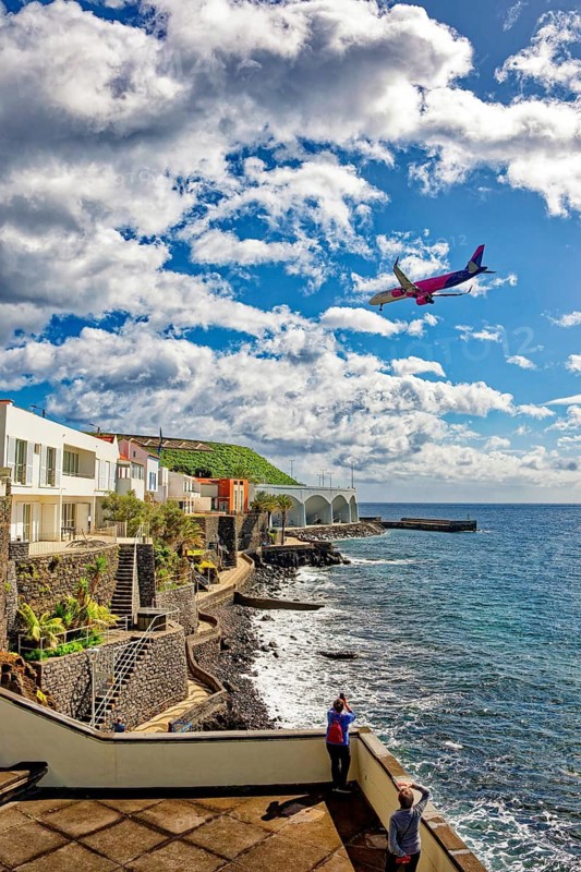 Aeroplane approaching Madeira airport, promenade on the Atlantic Ocean beach, municipality of Santa Cruz, Madeira, Portugal
