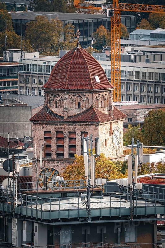 An old church with a red dome stands in contrast to modern buildings in an urban autumn scene, Stuttgart, Germany