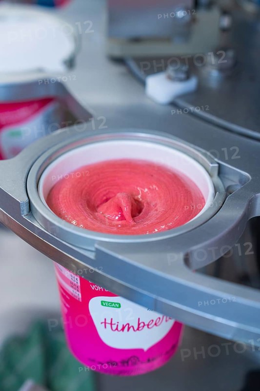Pink raspberry ice cream is filled into a vegan sundae, ice cream production farm ice cream, Haselstaller Hof, Wildberg, Black Forest, Germany