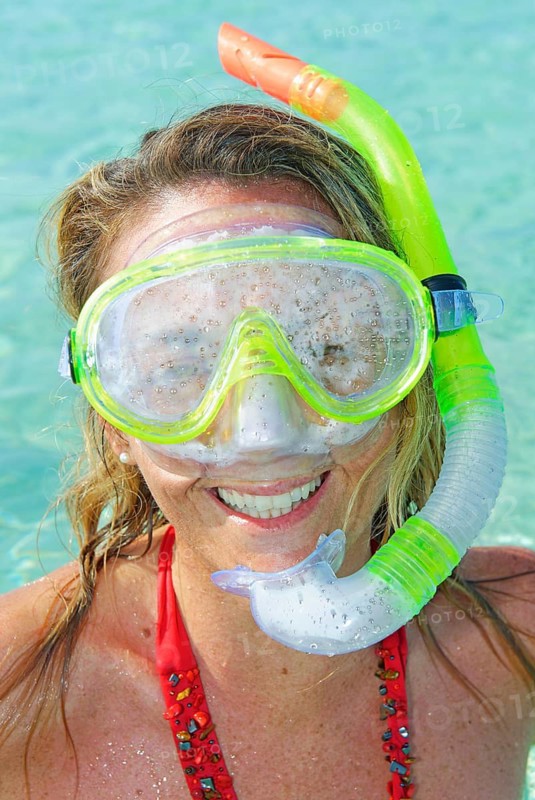 A woman smiling wearing snorkeling gear, Formentera, Baleric Islands, Spain