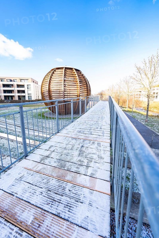 Wooden ball structure next to a wooden path with metal railing under a blue sky, forest ball from the 2012 State Garden Show, Nagold, Black Forest, Germany