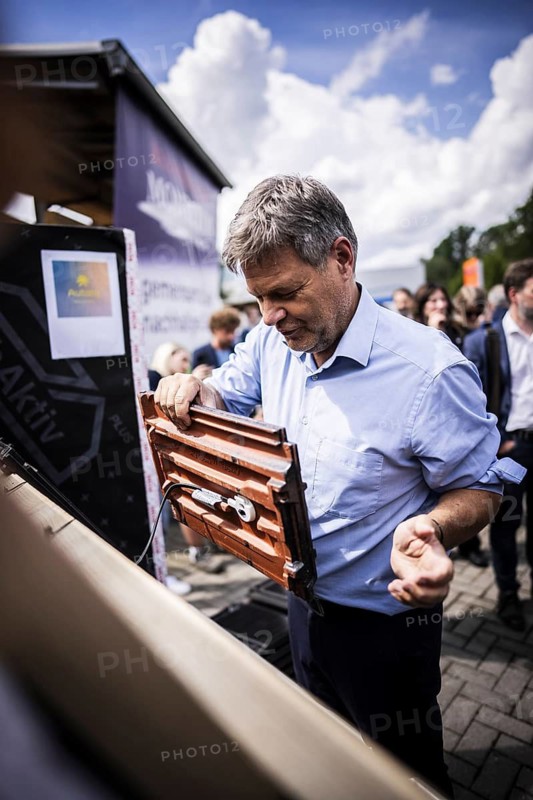 Federal Minister for Economic Affairs and Climate Protection Robert Habeck (Alliance 90/The Greens) on a summer tour of Germany. Here in Bochum, 10 July 2024, visiting a roofer with solar roof elements Photographed on behalf of the BMWK