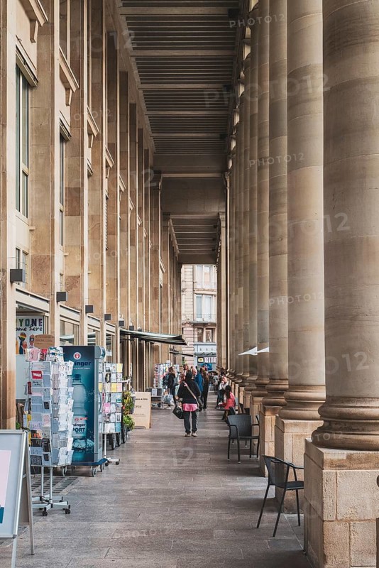 Elegant arcade with tall columns and people walking in a historic city area, Königsbau am Schlossplatz, Stuttgart, Baden-Württemberg, Germany