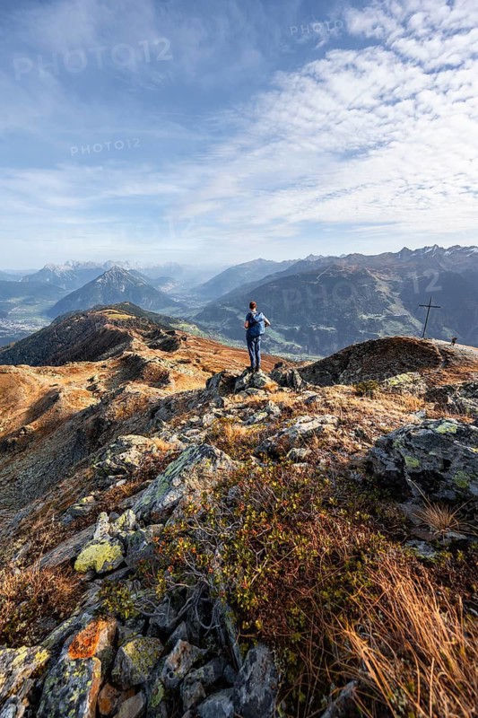 Mountaineers at the summit Kreuzjoch, view of summit Tschirgant and the Upper Inn Valley, mountain panorama in autumn, Venet crossing, Ötztal Alps, Tyrol, Austria