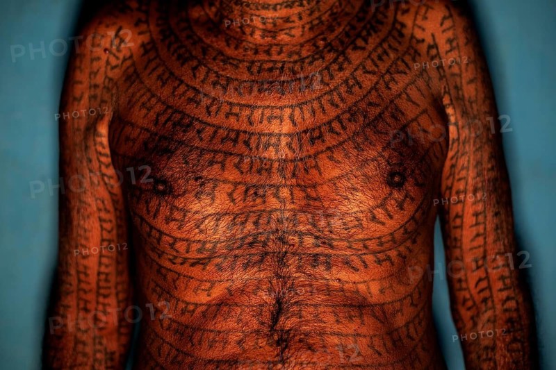 Torso of a 70 years old man from the Ramnami sect (Chhattisgarh, India), As a sign of devotion, Ramnami people tattoo their body and face with the name of Rama, one of the main hindu god. Nowadays, this tradition is disappearing. Indeed, few of them are still tattooed, the younger generation fearing discrimination. The community (or sect) is born in the end of the 19th century as a way to protest against the supremacy of the higher classes in the hindu hierarchical system. Comprised of low caste hindus, they dont accept the caste system, they practise a form of bhakti (devotion) dedicated to the god Rama