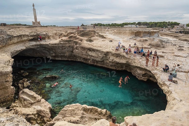 ROCA VECCHIA, ITALY - SEPTEMBER 28, 2018: Grotta Della Poesia is a very popular tourist attraction in region Plugia. People jump to the water from the rock