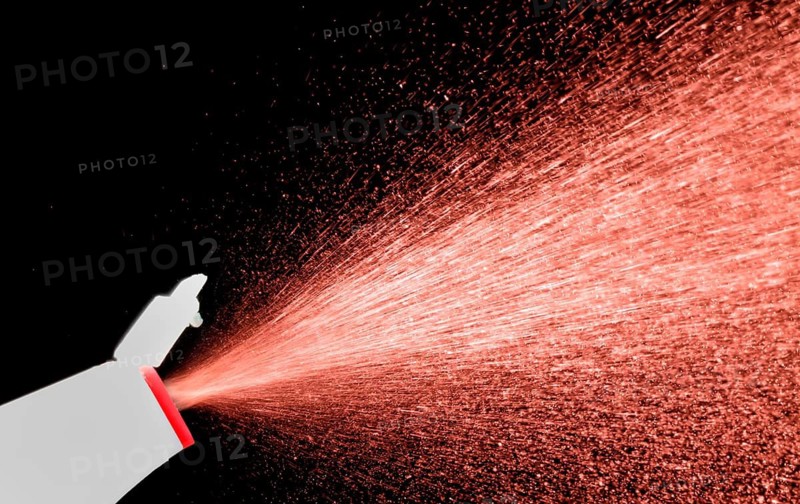 A fine spray of glass cleaner, colored against black background