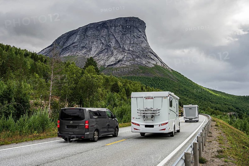 Car overtakes motorhomes, road E6, granite rock formation Krakmo, Norway