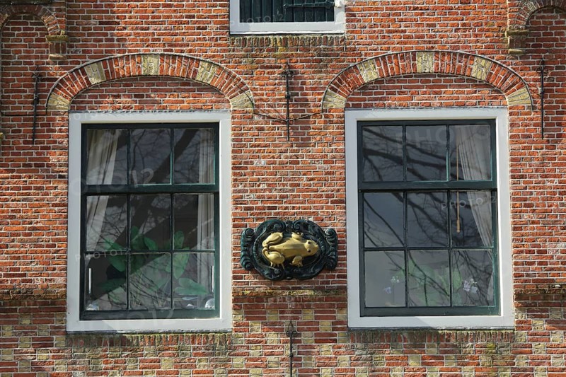 House façade with two windows and frog figure, brick house, Den Burg, Texel, North Holland, Holland, Netherlands
