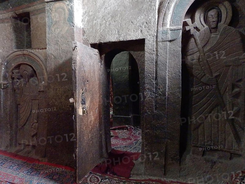 A room with stone reliefs and a slightly open door in a sacred context, UNESCO World Heritage Site, Lalibela Rock Church, Ethiopia