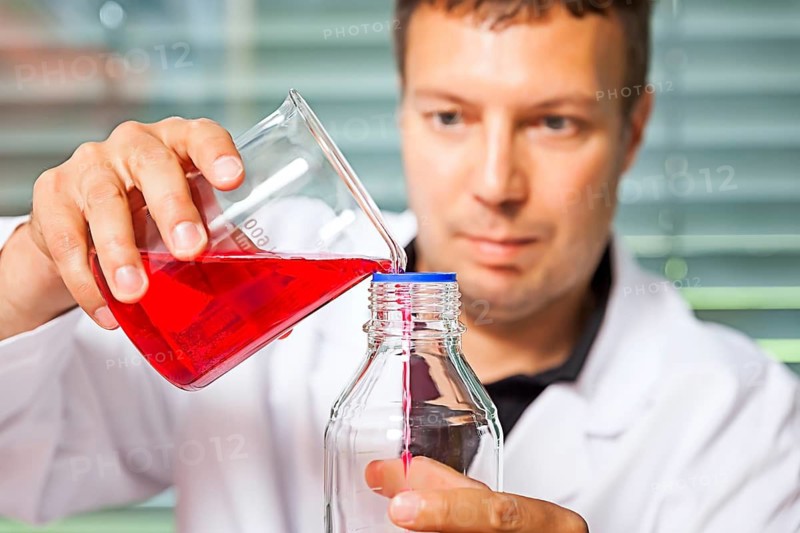 A young laboratory technician experimenting with chemicals, chemist, laboratory, Federal Republic of Germany
