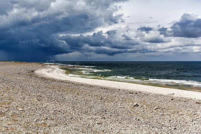 Lonely pebble beach, dramatic storm clouds, rain showers, Langhammars Nature Reserve, Fårö Island, Gotland, Baltic Sea, Sweden