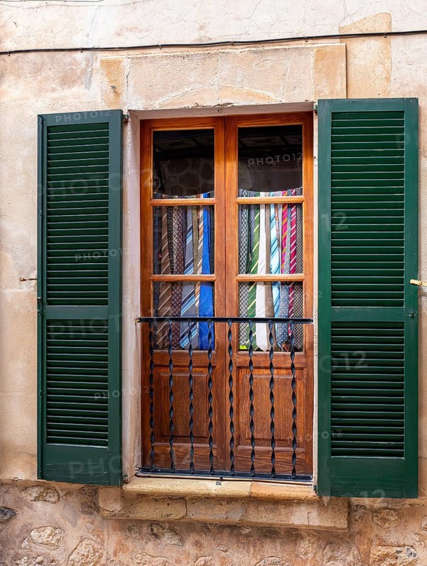 Windows in which old ties serve as curtains, Valdemossa, Majorca, Spain