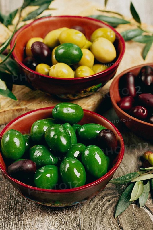 A mixture of olives, varieties of chalkidiki, Verdi giganti and Kalamata, in a bowl, top view, no people