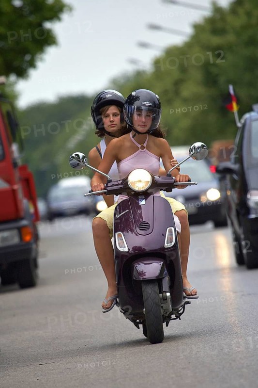 Two woman riding a scooter, Barcelona, Spaina