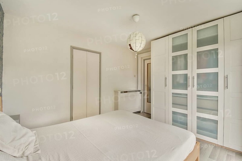 A sleek, modern bedroom showcasing minimalistic design with a clean aesthetic and stylish furniture, perfect for contemporary living