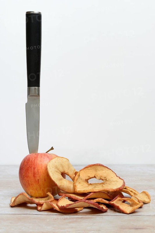 Apple with knife and apple rings, dried fruit